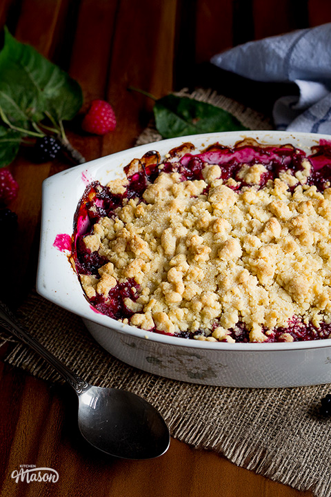 Apple and berry crumble in a dish over a sheet of hessian.