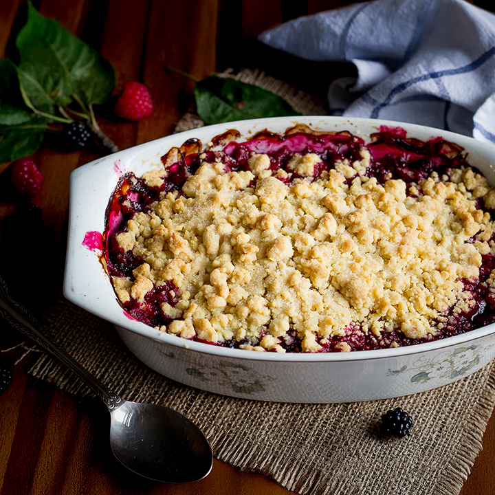A Summer fruit crumble in a decorative dish.