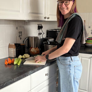 Emma chopping vegetables in her kitchen