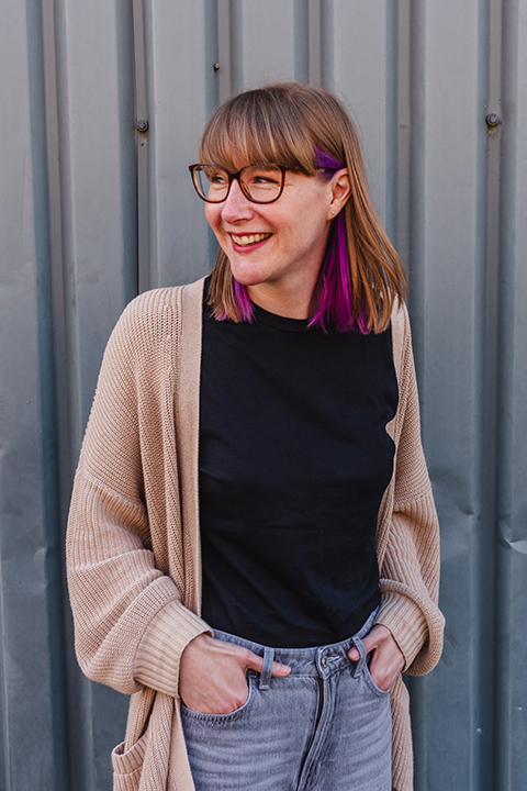 A happy Emma smiling off camera.