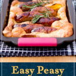 Light, golden and fluffy toad in the hole in a roasting dish on a black tea towel. A text overlay says "Easy Peasy toad in the hole".