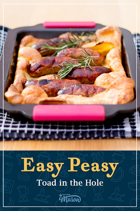 Light, golden and fluffy toad in the hole in a roasting dish on a black tea towel. A text overlay says "Easy Peasy toad in the hole".