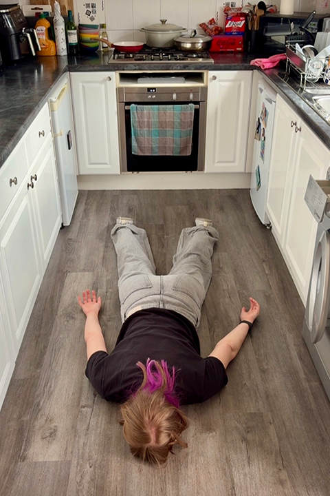 An exhausted burnt out Emma lying face down on her kitchen floor, REALLY not wanting to cook dinner.