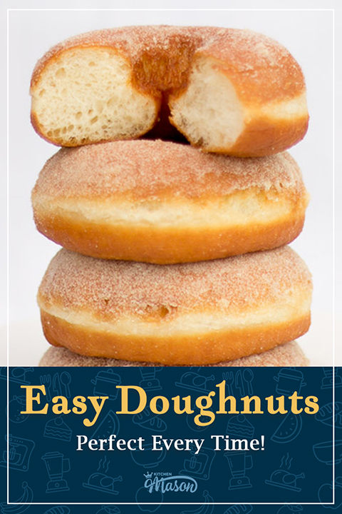 A stack of homemade sugared homemade ring doughnuts, the top one is cut in half to show it's fluffy interior texture. A text overlay says "Easy doughnuts, perfect every time!".