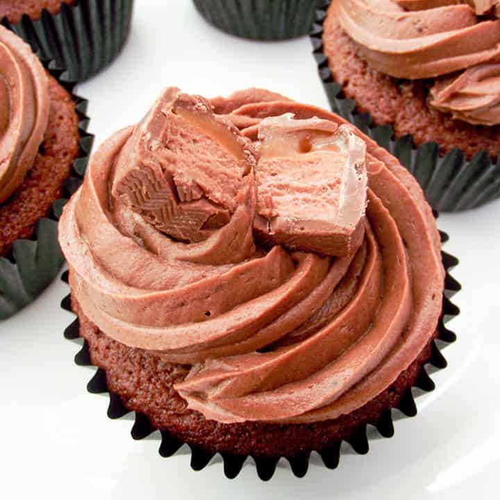 A chocolate Mars Bar cupcake on a white plate.