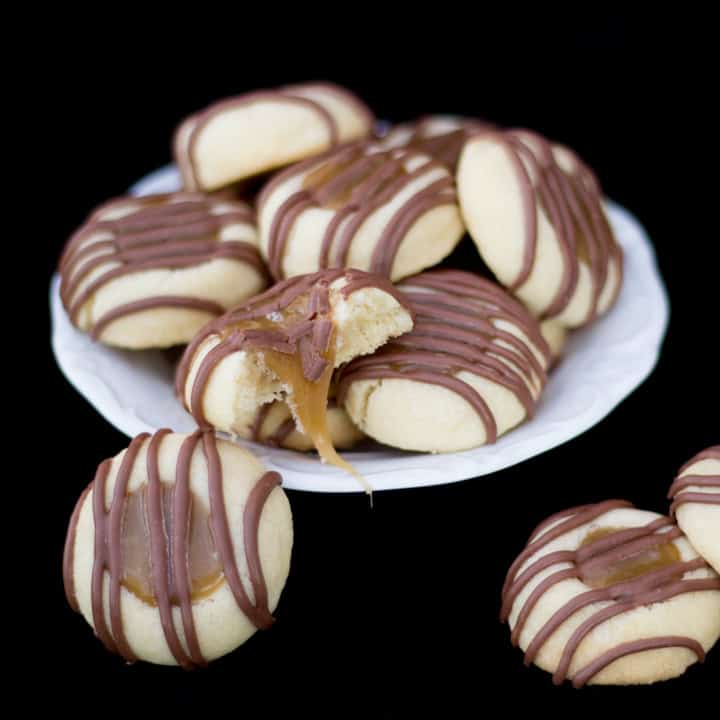 A plate filled with Twix thumbprint cookies.